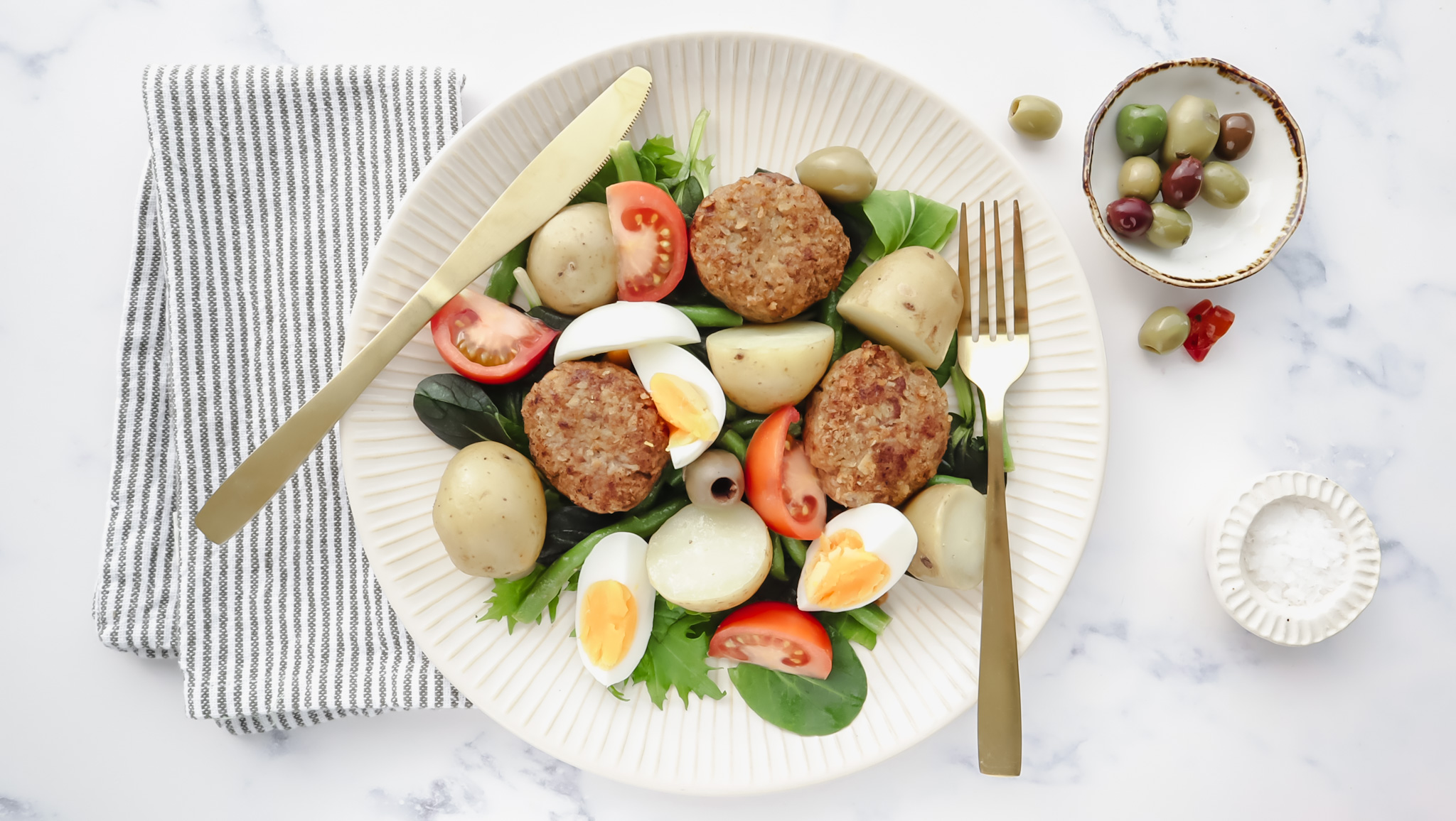 Juicy lamb rissoles with Nicoise salad, beans & egg recipe