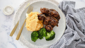 Beef meatballs with caramelised onion gravy, creamy mash & greens recipe