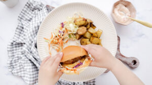 Pork & pineapple burgers with sweet chilli glaze, slaw & roasties recipe