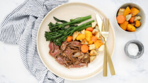Beef & caramelised onion gravy with roasties & broccolini recipe