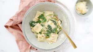 Cheesy ravioli with leek, peas & creamy herb sauce recipe