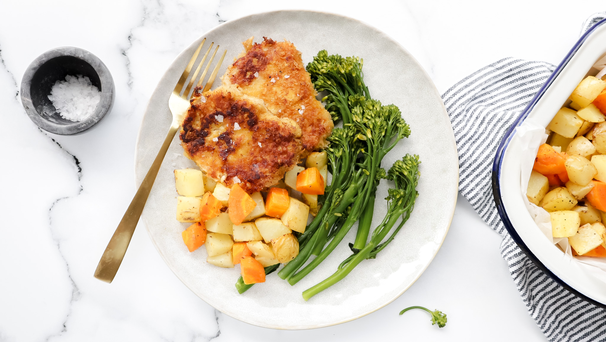 Crispy parmesan pork fillets with garlic roasties, greens & aioli recipe