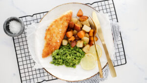 Panko crumbed fish with salt & vinegar roasties, mushy peas & garlic aioli recipe