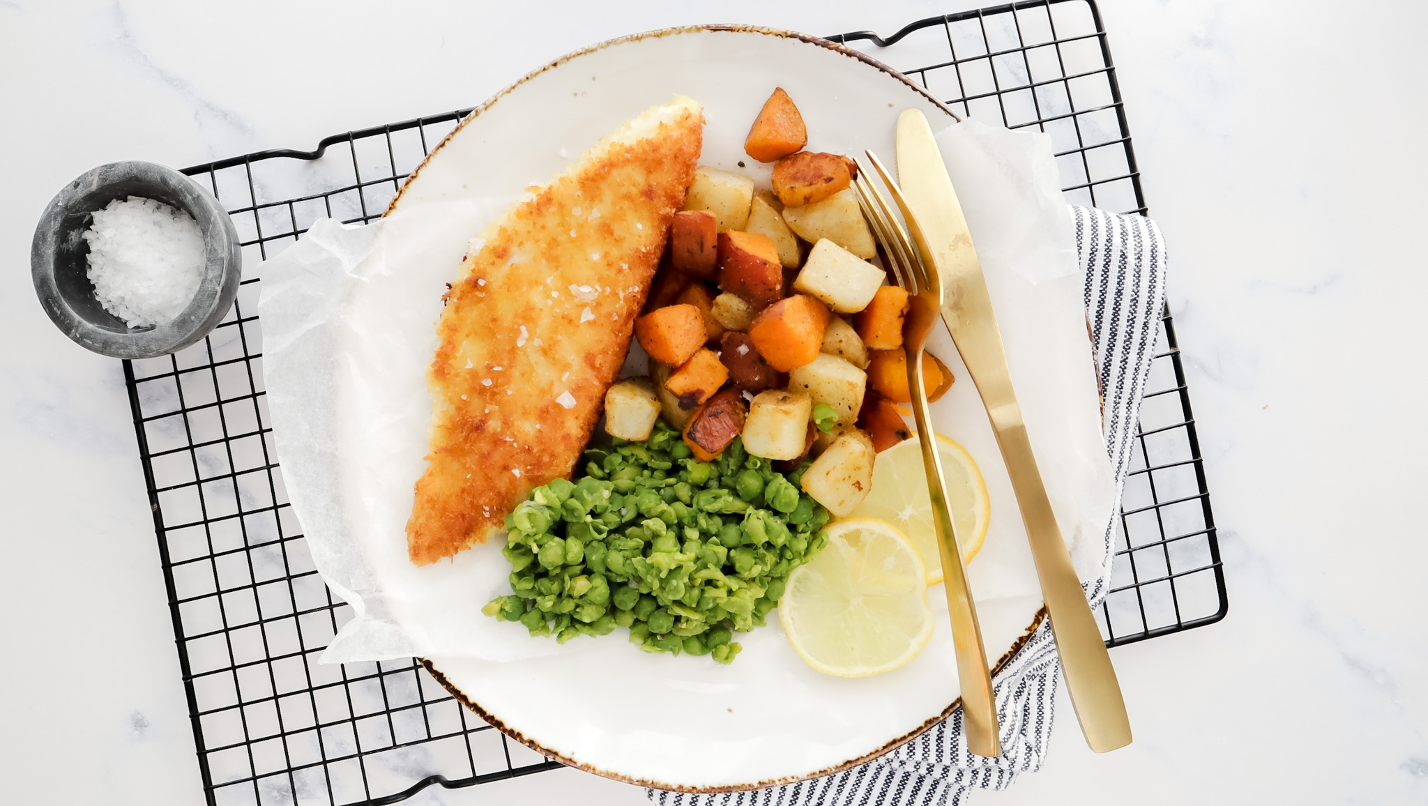 Panko crumbed fish with salt & vinegar roasties, mushy peas & garlic aioli recipe