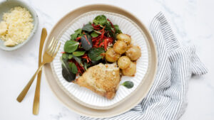 Roasted chicken, crispy parmesan baby potatoes with sour cream & salad recipe