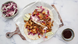 Sticky pork tacos with pineapple & tomato salsa & slaw recipe