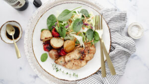 Tasty chicken bake with blistered tomatoes & garlic thyme potatoes recipe