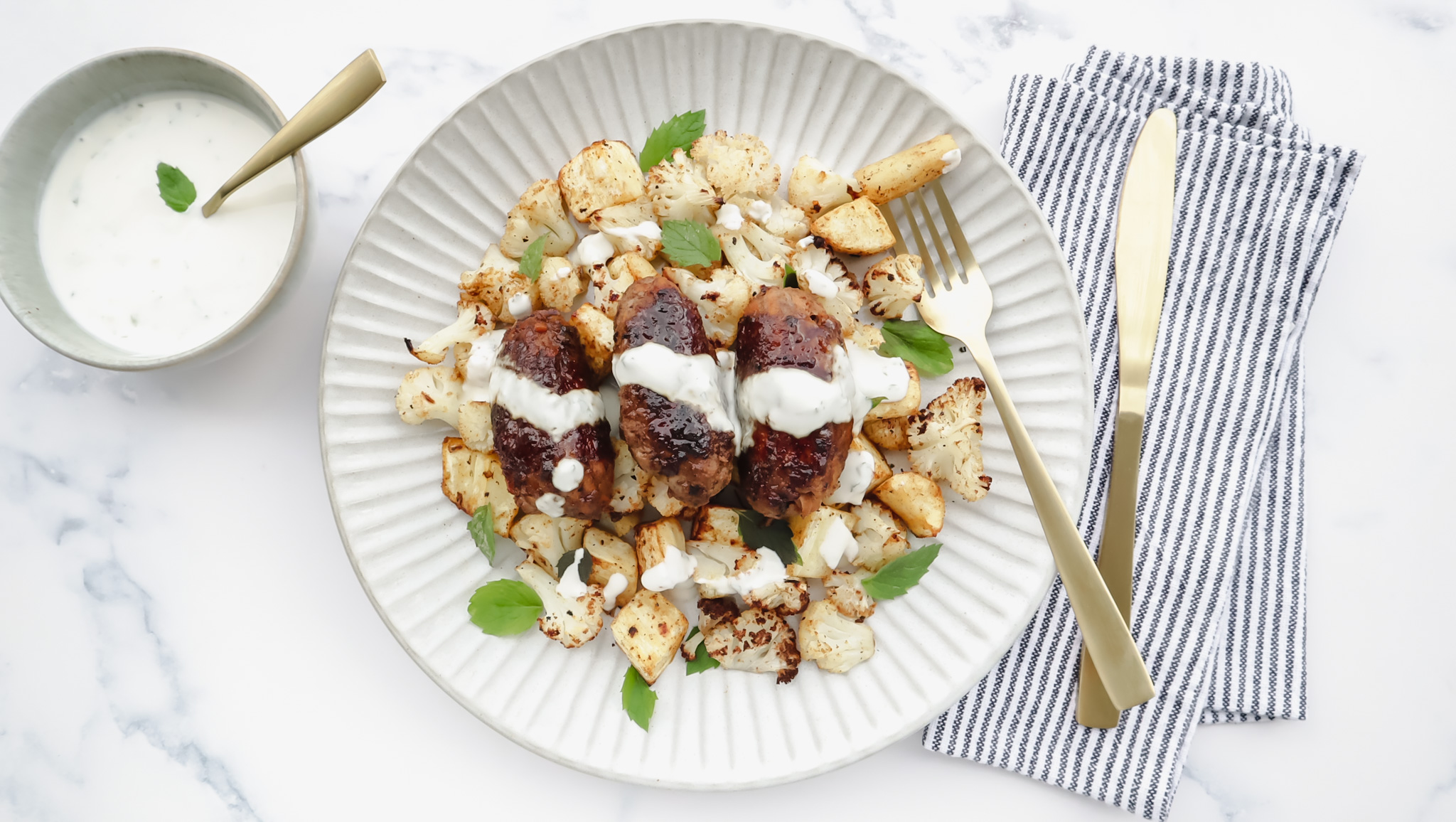 Beef koftas with honey glaze, roasted cauli & mint yoghurt drizzle recipe