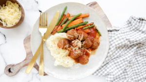 Cheesy lamb meatballs in tomato sauce with cauli mash & veggies recipe