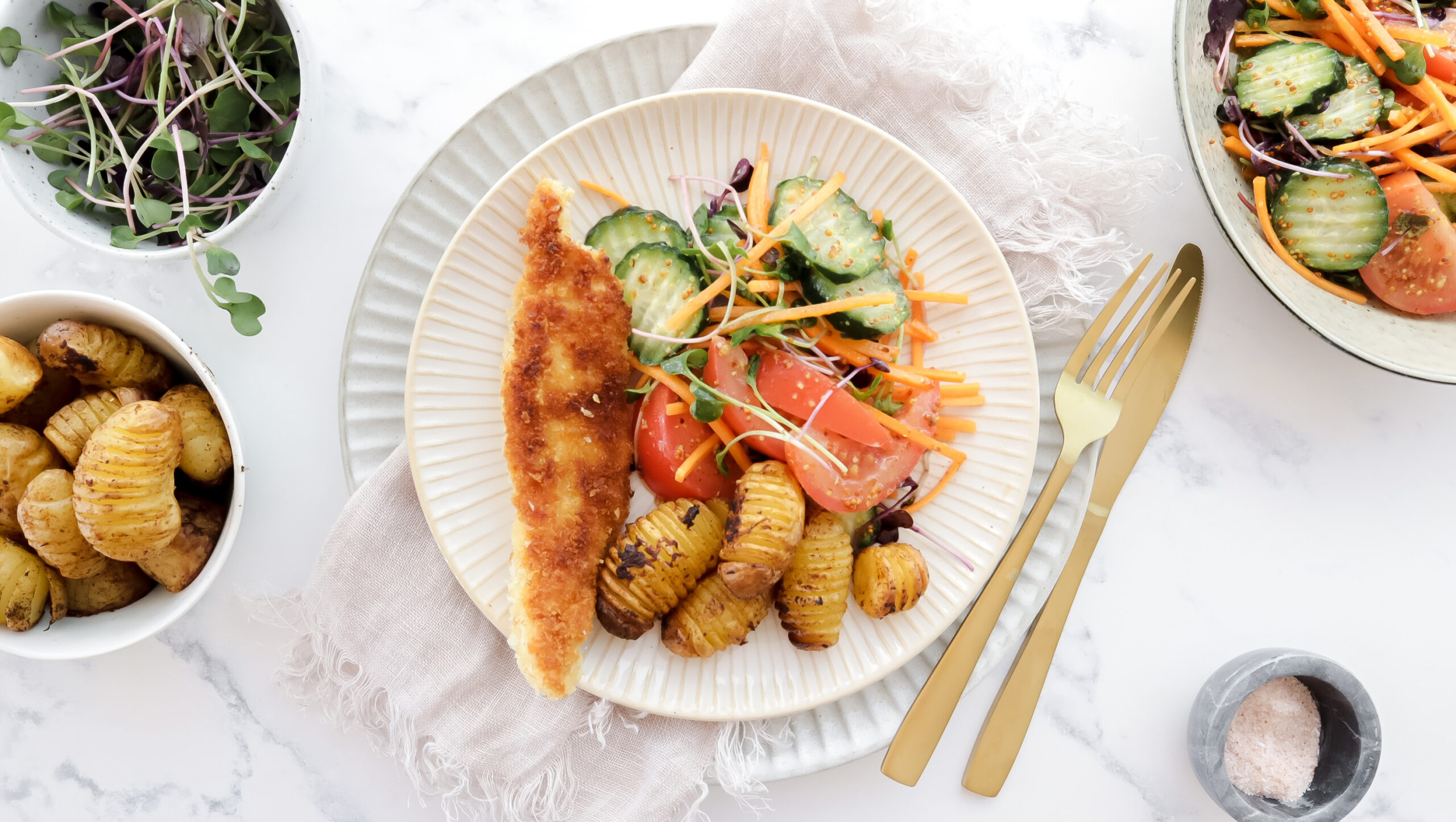 Crispy chicken schnitty, baby hasselback potatoes & salad recipe