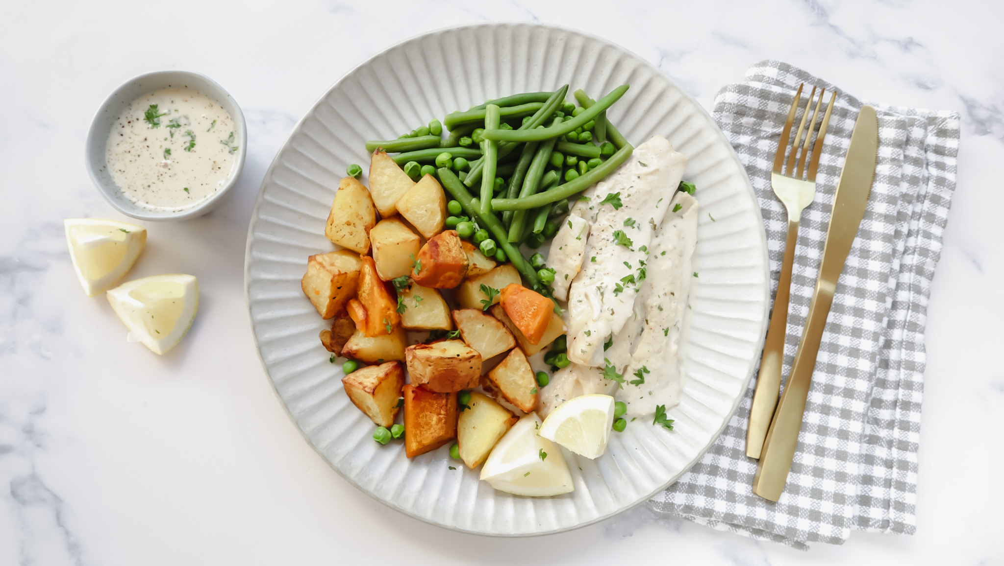 Fish with creamy parsley sauce, veggie roasties & greens recipe