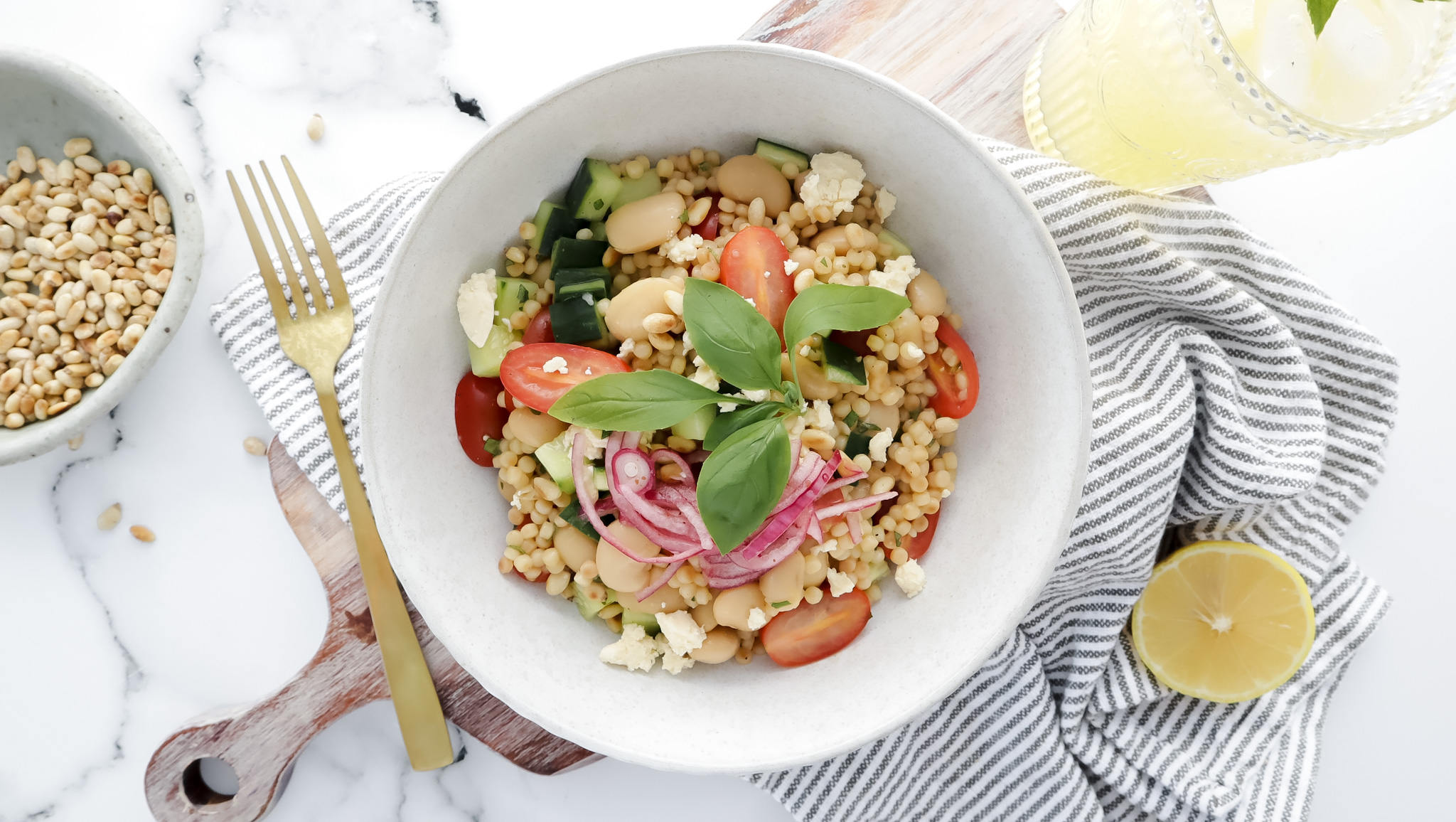 Pearl couscous with cherry tomatoes, feta, pickled onions & pine nuts recipe