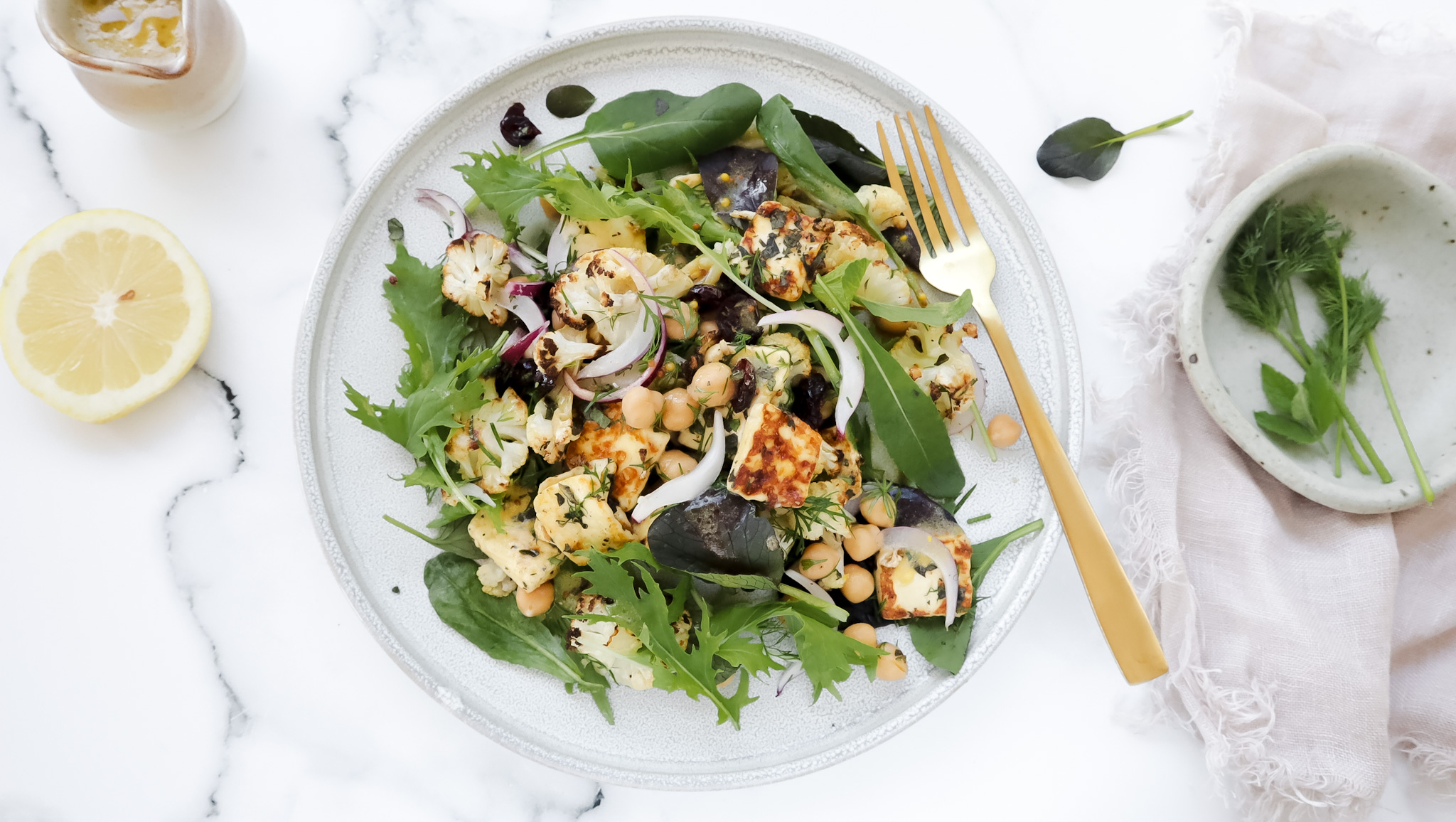 Roasted cauli, chickpea & haloumi salad with almonds & pine nuts recipe