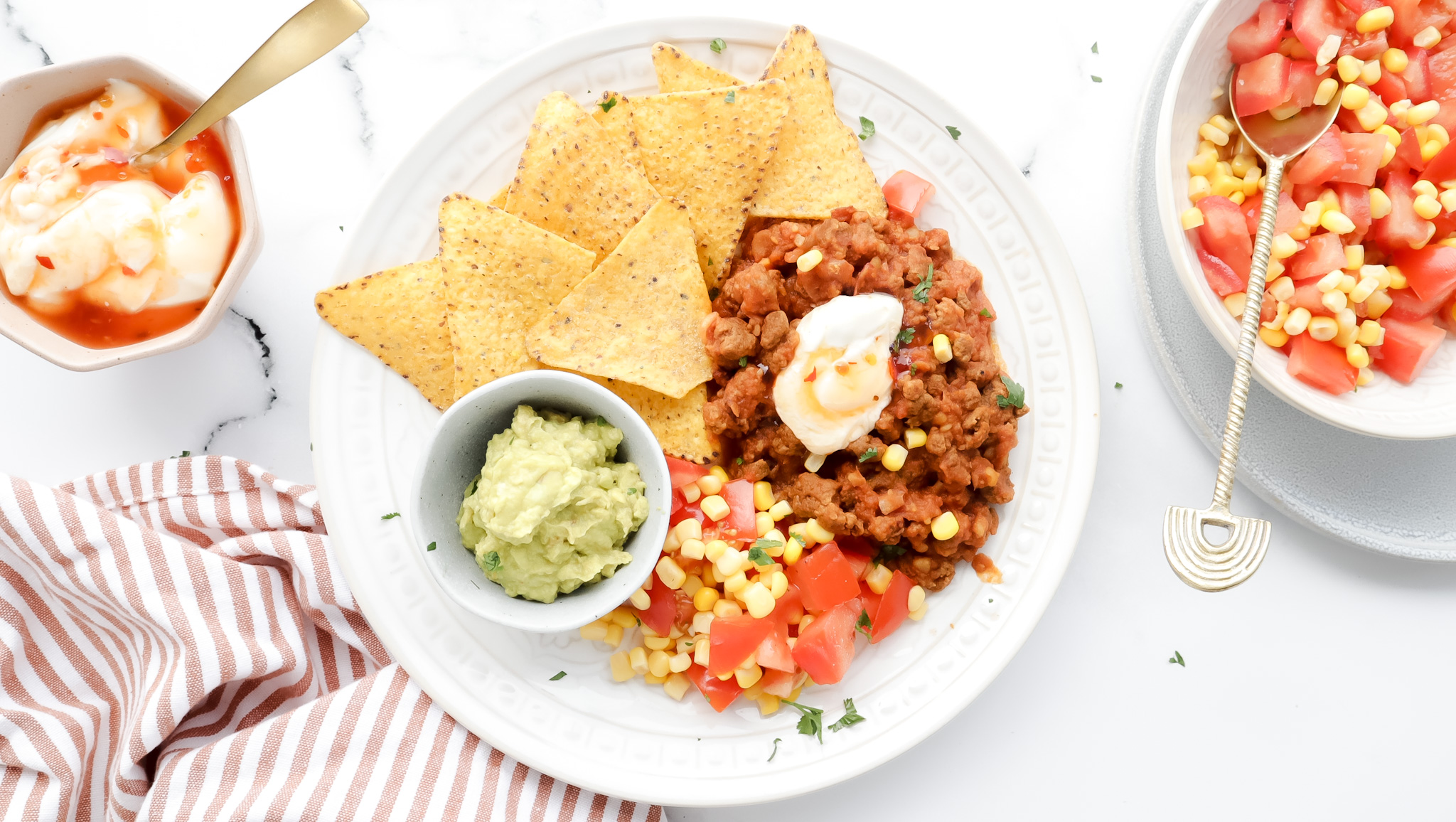Mexican beef & bean nachos with corn salsa, sour cream and guac recipe