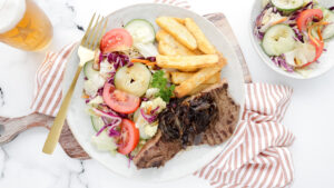 Pub-style steak with caramelised onion, hand-cut chips & house salad recipe