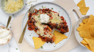 Chilli con carne-style veggie loaded sweet potato with corn chips & sour cream recipe