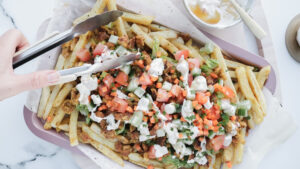 Mediterranean-style falafel crumb & loaded fries with peach & mango drizzle recipe