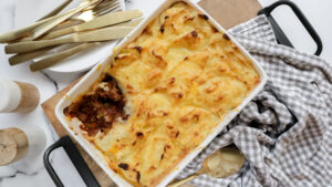 Savoury beef & caramelised onion pie with cheesy potato top & cucumber salad recipe