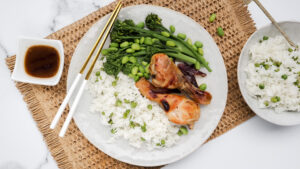 Sticky honey soy chicken nibbles with pea rice & steamed greens recipe