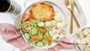 Crispy pork schnitzel with mustard sauce, creamy potatoes & cucumber cos salad recipe